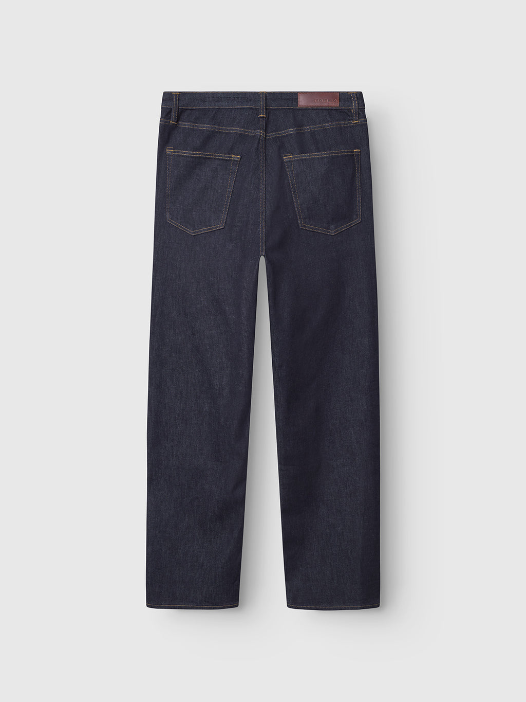 The Gabba Noah Self - Dark Blue Denim jeans feature sustainable fabric, two rear pockets, brown stitching, and a small rectangular leather patch on the back waistband.