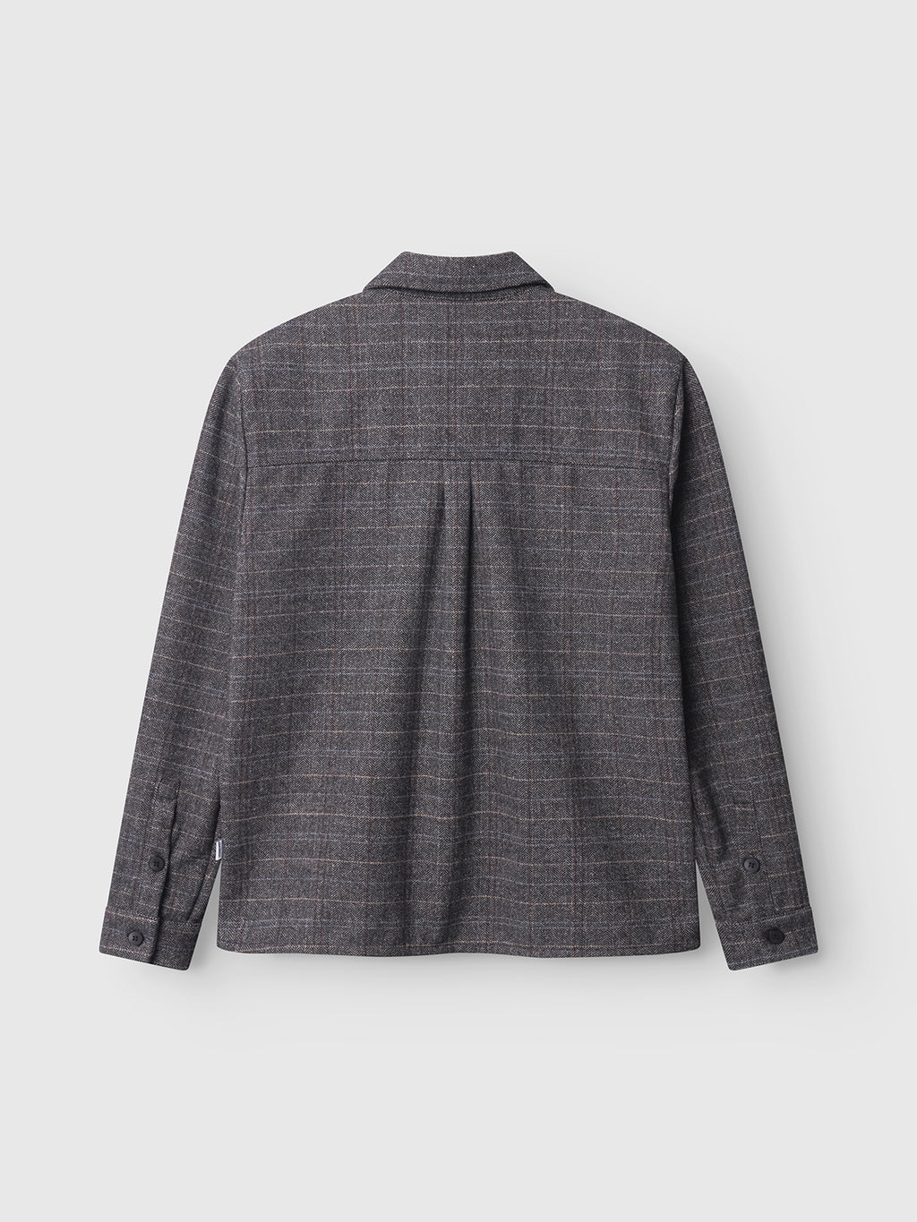 The Gabba Flap Tishi in Brown Check is shown from the back, featuring a straight hem, buttoned cuffs, and a subtle check pattern—making it an ideal men’s layering piece.