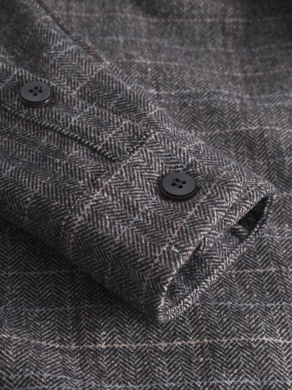 Close-up of the Gabba Flap Tishi - Brown Check sleeve, featuring two black cuff buttons and detailed texture—a refined men’s layering piece.