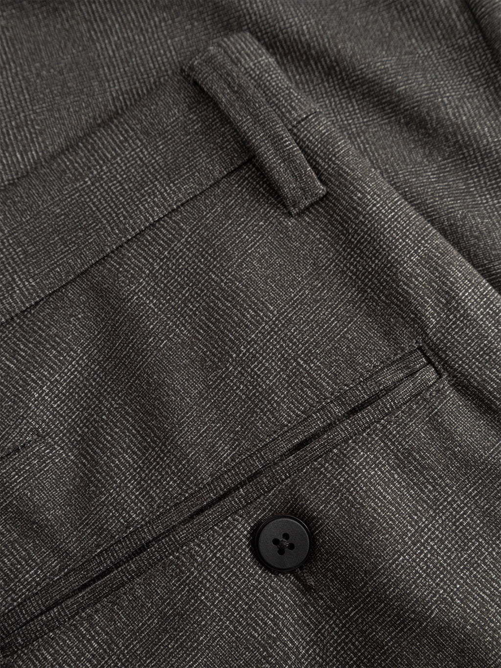 Close-up of the back pocket on Gabbas Paul Nygo - Grey slim straight cut trousers, showing a black button, tailored pocket details, and subtle grey plaid stretch fabric with visible stitching.