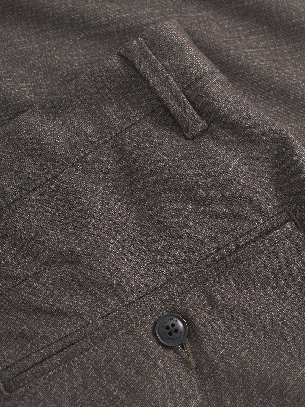 Close-up of Gabba Paul Nygo - Dark Brown slim straight trousers, featuring textured fabric, a belt loop, back pocket with black button, and visible stitching for stylish detail and stretch comfort.