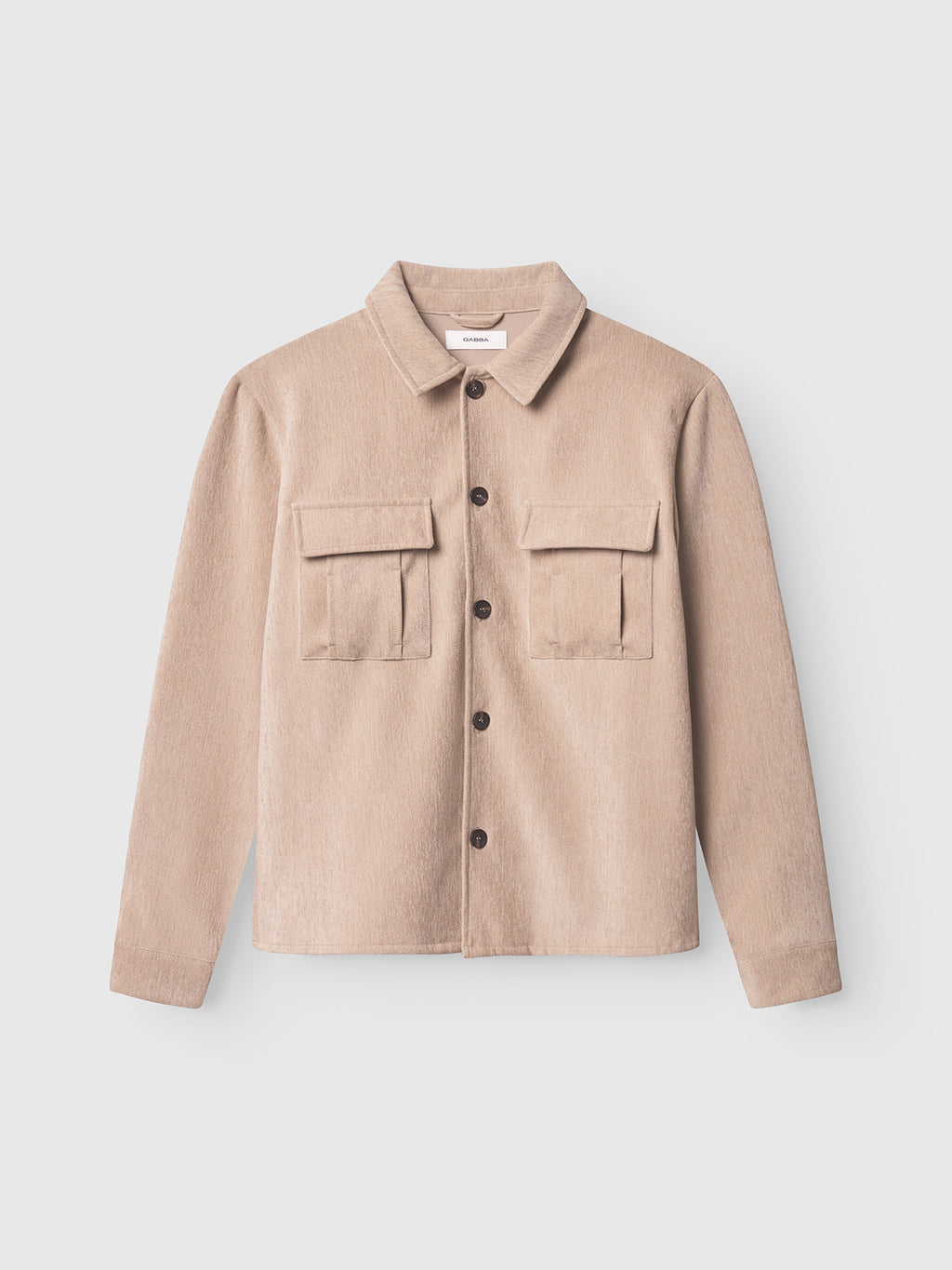 The Gabba Flap Velour - Lt. Sand is a light beige regular-fit overshirt with a collar, long sleeves, and two front flap pockets, crafted from soft fabric and shown on a plain white background.
