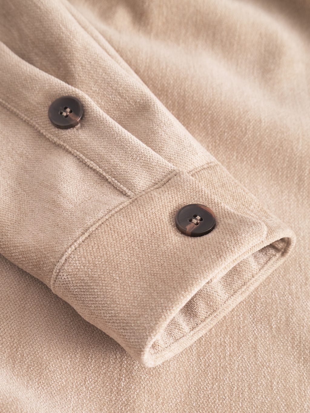 Close-up of Gabba’s Flap Velour - Lt. Sand overshirt sleeve featuring two dark brown buttons and visible stitching, highlighting the soft, textured velour fabric.