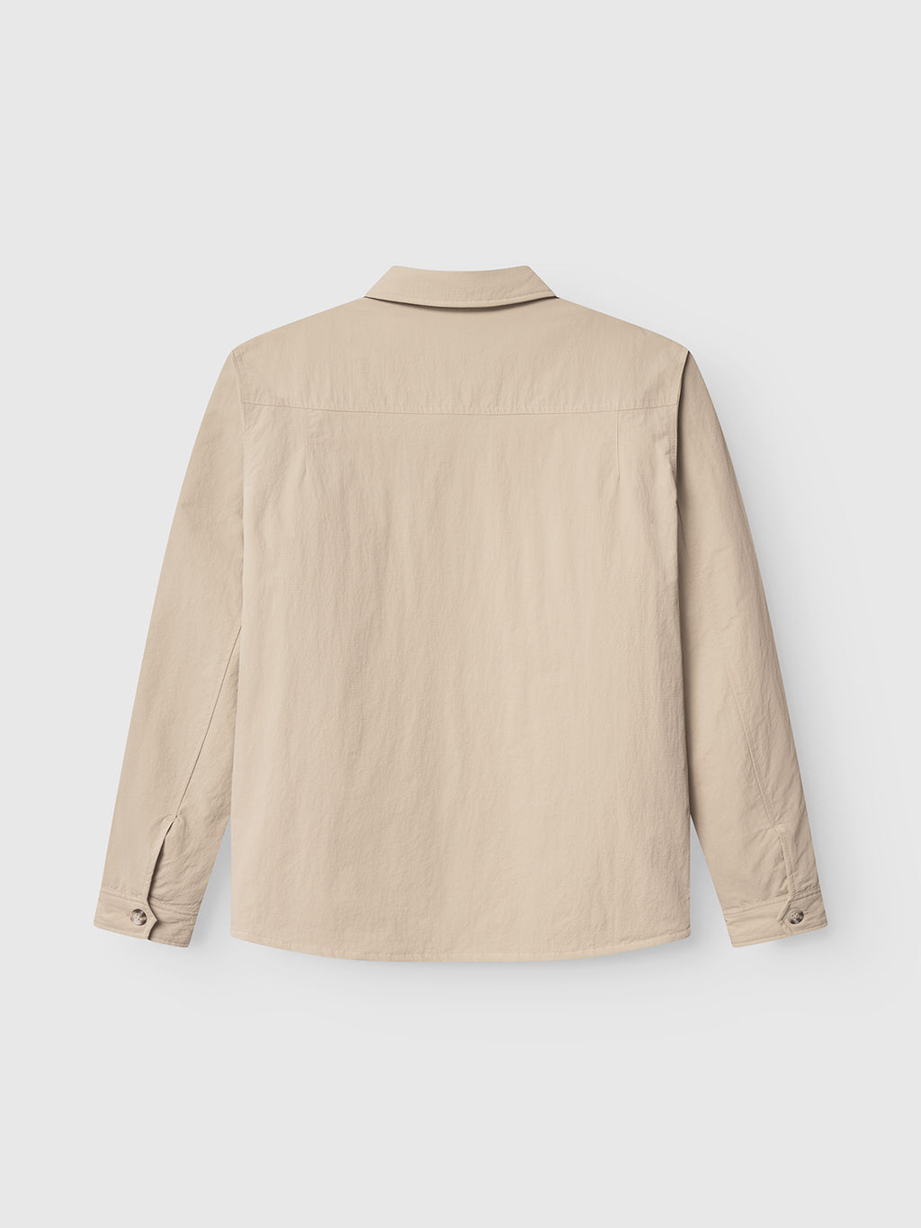 The Nara Goz - Lt. Sand overshirt by Gabba is shown from the back, laid flat on a white background. This beige, regular-fit shirt features long sleeves, a collar, and buttoned cuffs, with no visible patterns or logos.