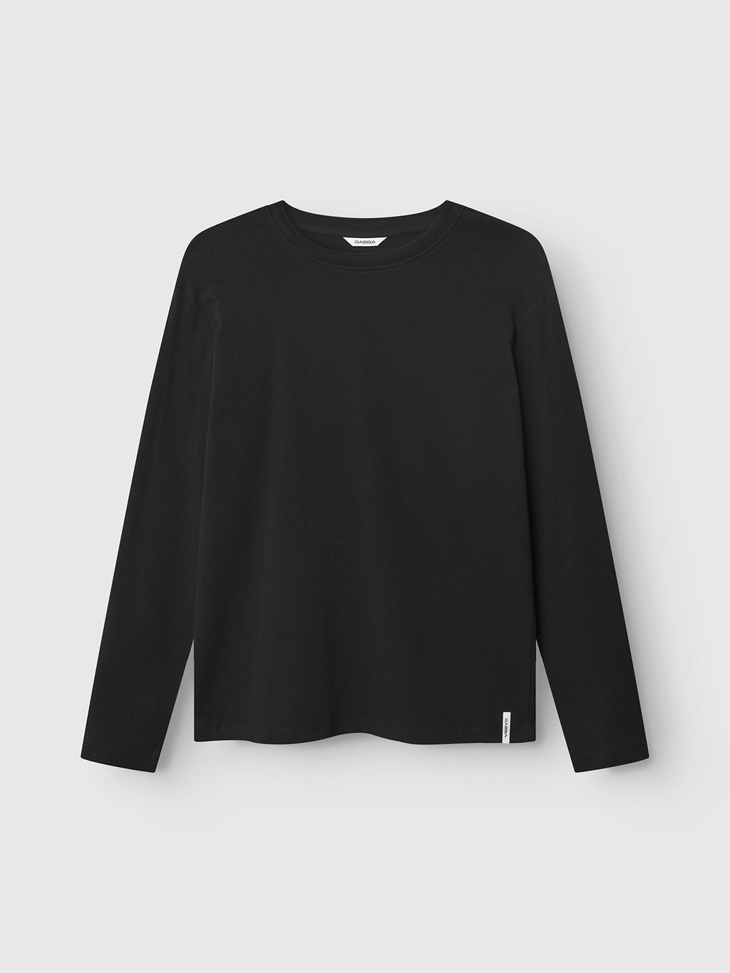 The Dune Brush LS - Black by Gabba is a versatile long-sleeved tee with a crew neckline and a small white tag on the lower left side, shown against a light grey background—perfect for any modern wardrobe.