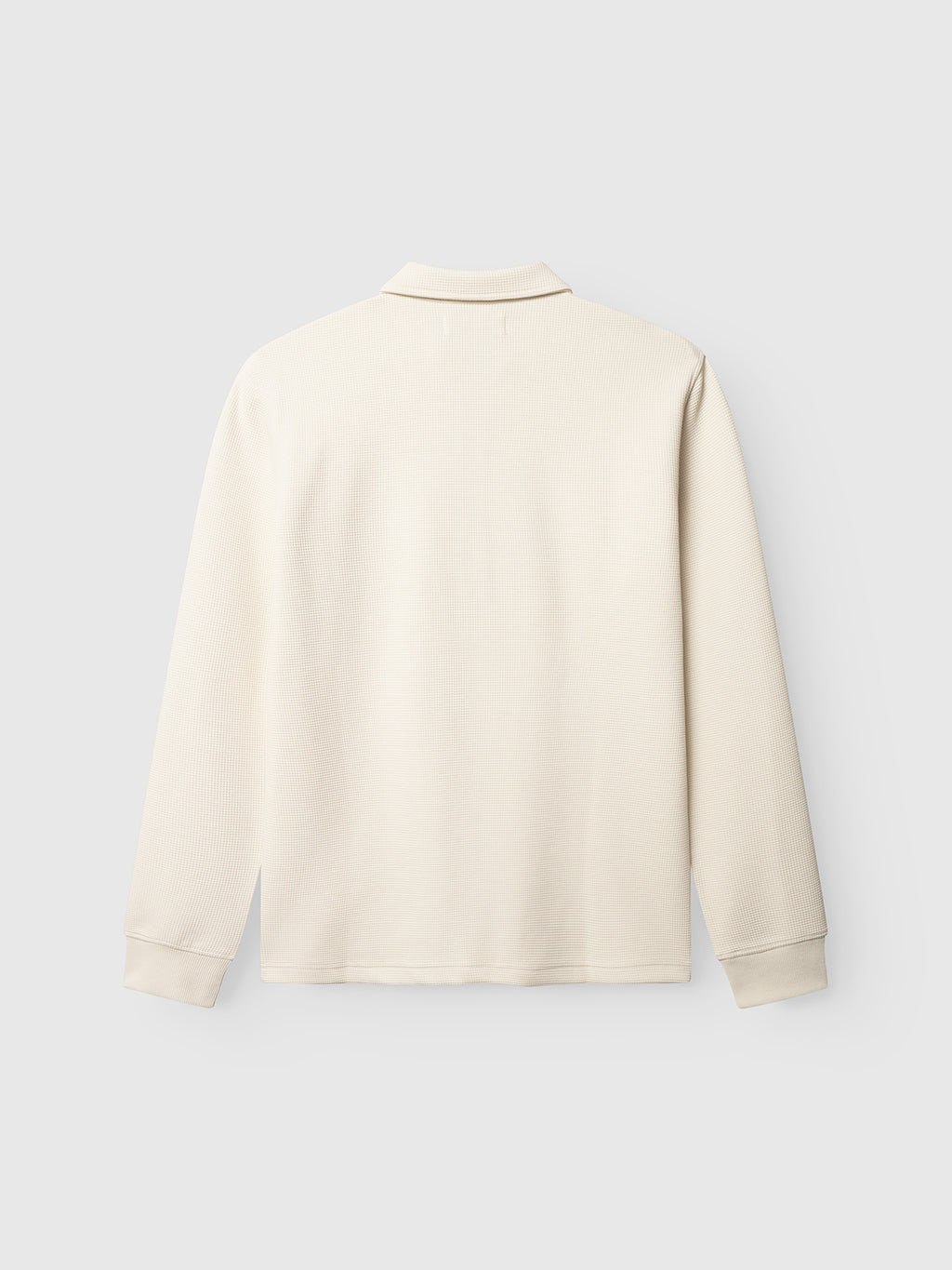 The Gabba Island Waff - White Almond, a cream-colored, long-sleeve waffle knit shirt with a collar, is shown from the back against a plain light gray background.