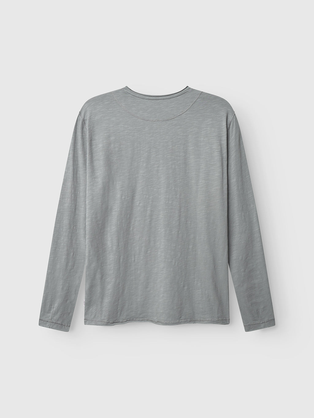 The Kostant New LS by Gabba is a plain, long-sleeved t-shirt in Dust Sage Green, shown from the back on a white background. Made from midweight slub jersey, it has a round neckline with no visible designs or logos.
