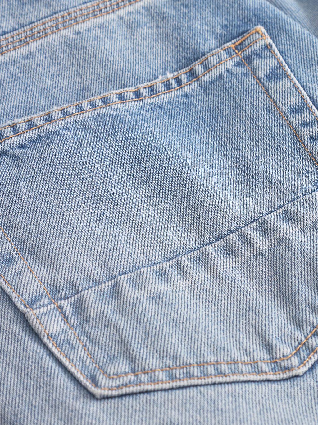 Close-up of Gabba’s Carl Prag - Lt. Blue Denim shows the back pocket with visible stitching and seams, highlighting the textured weave and worn look that give these loose tapered jeans their classic style.
