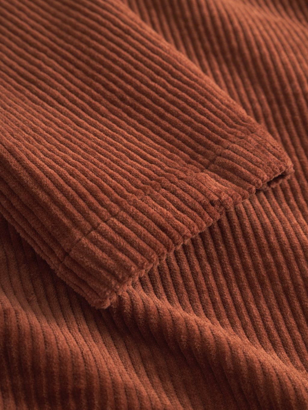 Close-up of Libre AX Cord - Brown Rust by Gabba, highlighting its textured, vertical ribbed pattern and soft, velvety surface—ideal for a men's shirt or corduroy overshirt.