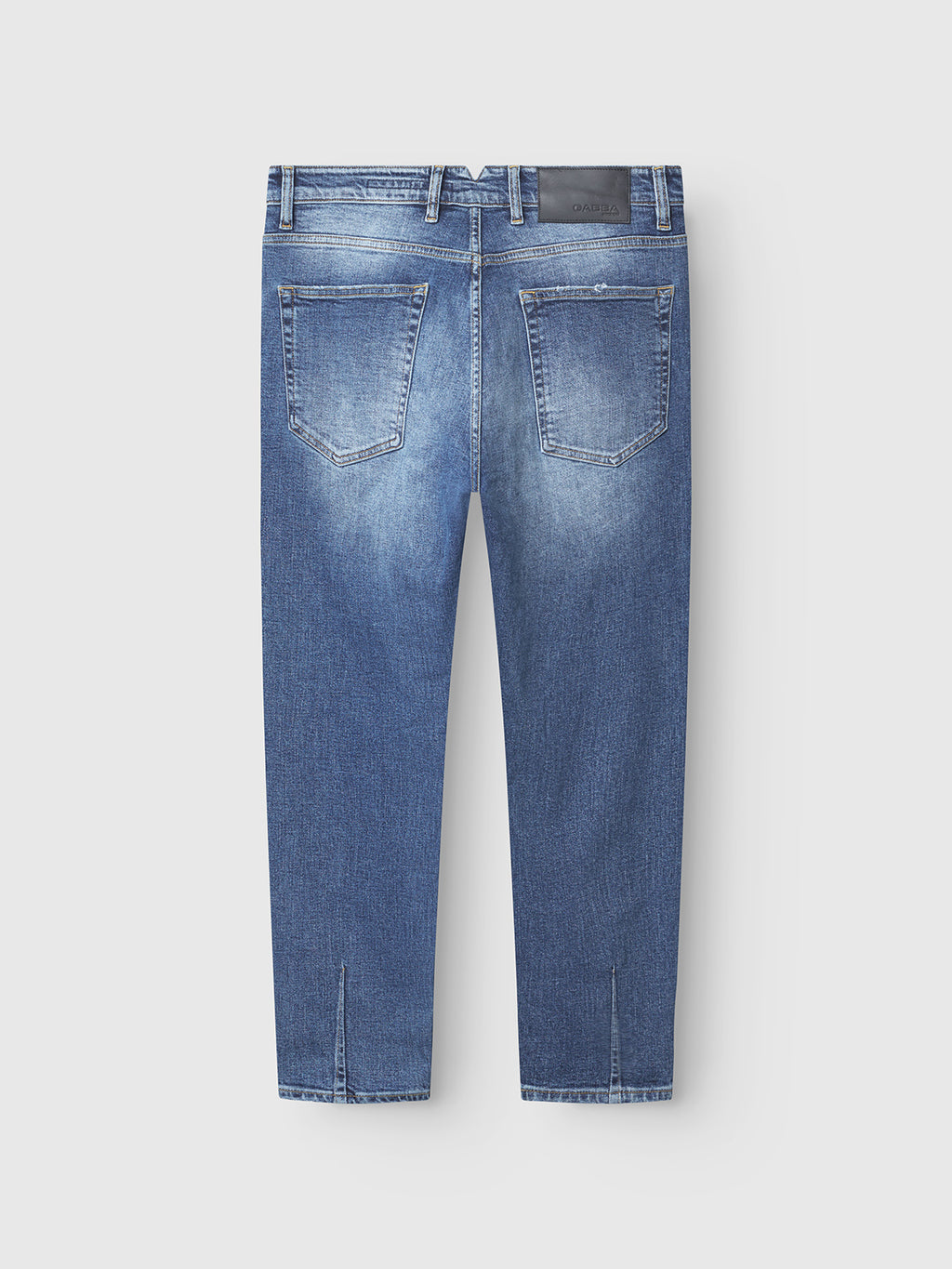 The Alex Cros - Mid Blue Denim jeans by Gabba feature comfort stretch denim, two rear pockets, belt loops, a black waistband patch, and small slits at the bottom of each leg. Shown from the back in a relaxed tapered fit.