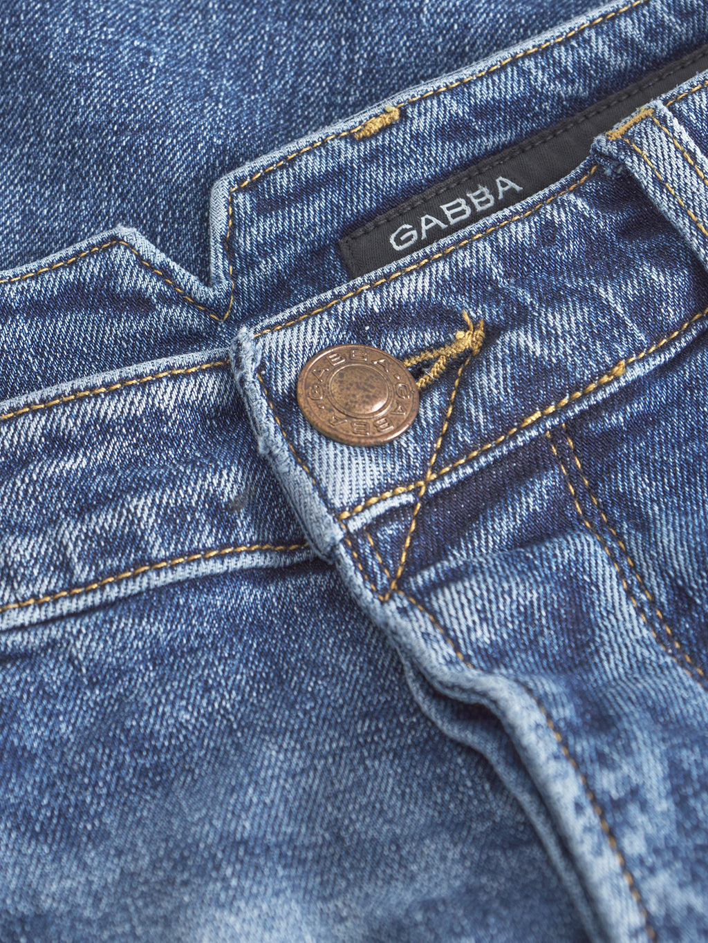 Close-up of Gabbas Alex Cros - Mid Blue Denim jeans, showcasing a bronze button, yellow stitching, and a black Gabba label near the waistband. Made from comfort stretch denim for style and ease.