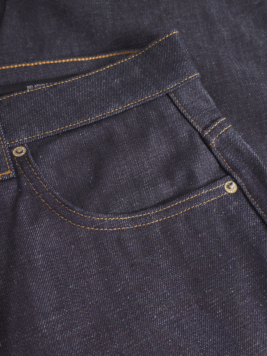 Close-up of Gabba Marc Tana dark blue denim straight-fit jeans, featuring a front pocket with orange stitching and metal rivet details.
