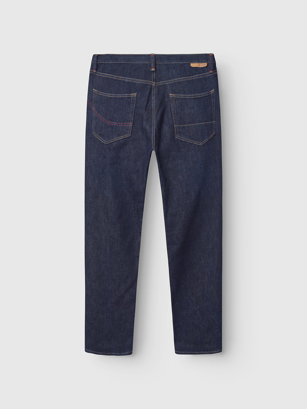 The Gabba Carl Anark Self jeans in dark blue denim feature Japanese-inspired design, two back pockets with contrast stitching, and a small brown leather patch on the waistband.