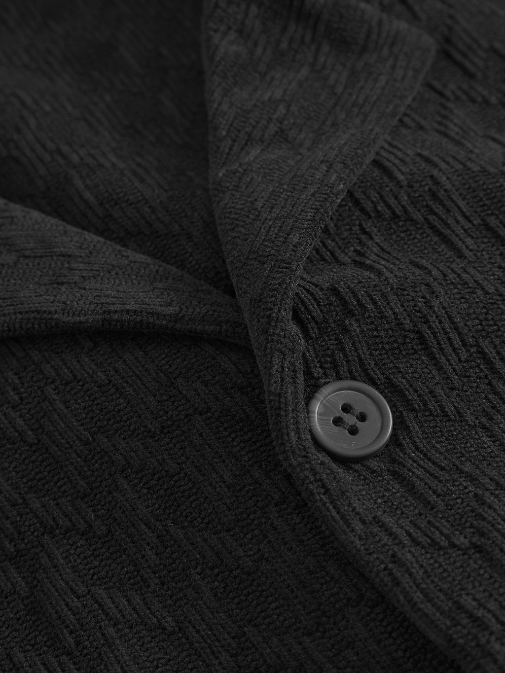 Close-up of the textured black diamond jacquard velvet fabric and zigzag pattern on the Gabba Jens Over Diam SS - Black shirt, featuring a black button and the folded edge overlapping slightly.
