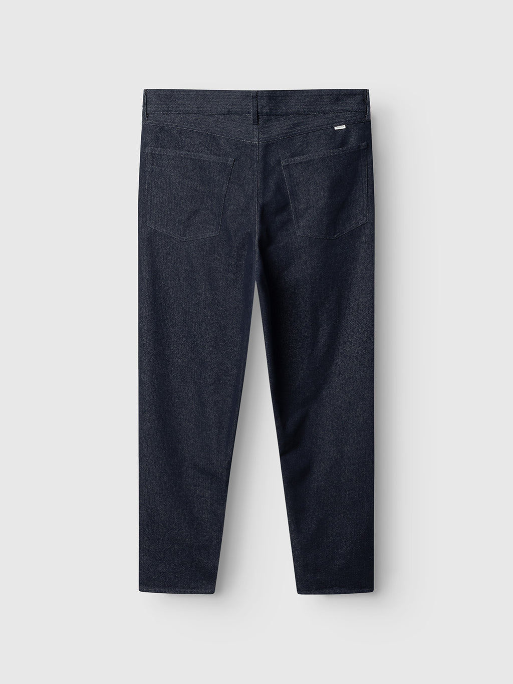 Gabba David Chev - Dark Navy jeans shown flat from the back, with two back pockets and a small white label above the right one, set on a light gray background. Subtle herringbone texture adds detail to the dark navy denim.