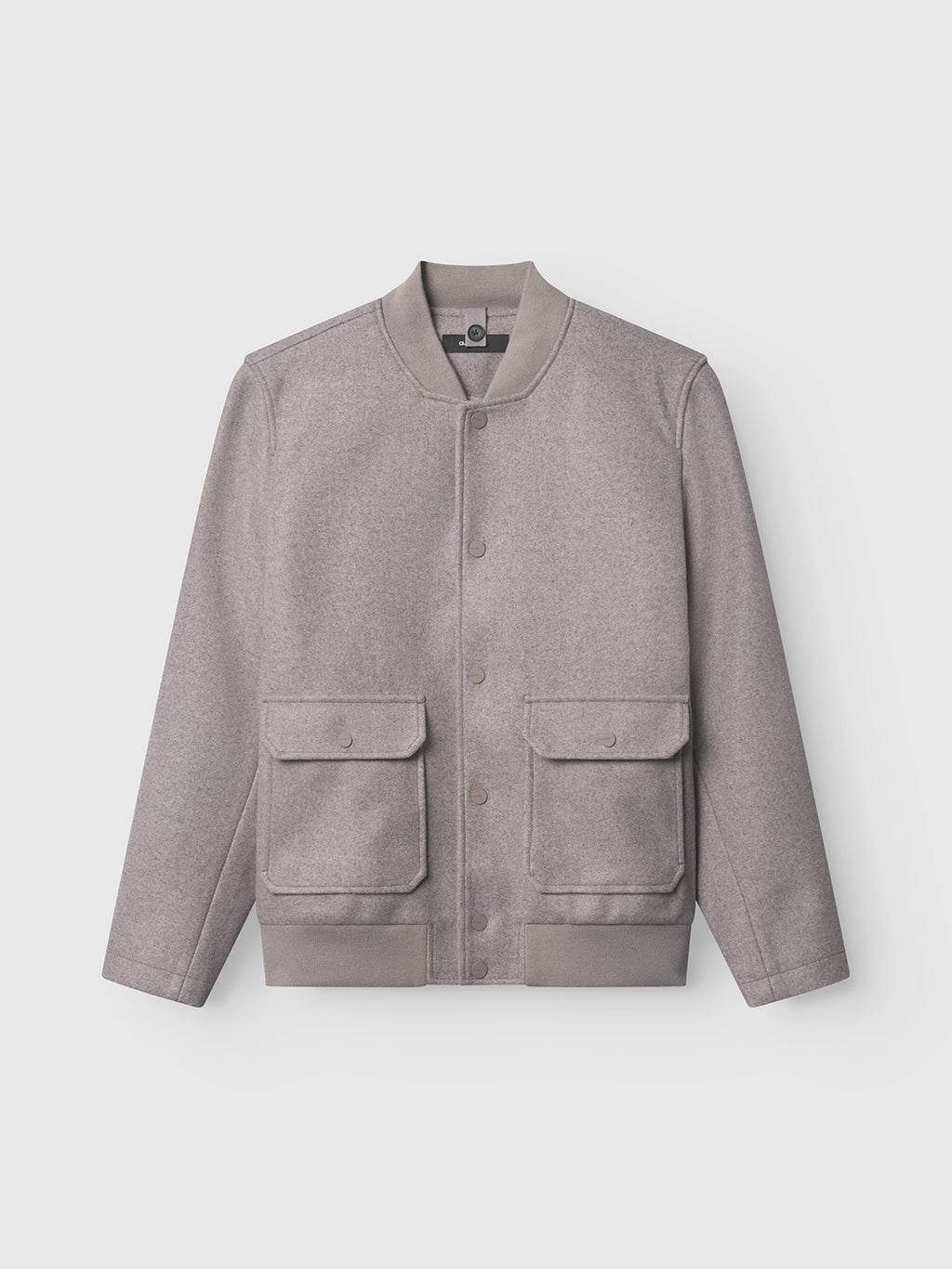 The Orta Wox - Sand by Gabba is a light grey wool-blend bomber jacket, collarless, with front snap buttons, ribbed cuffs and hem, two large front flap pockets, and is shown against a plain white background.