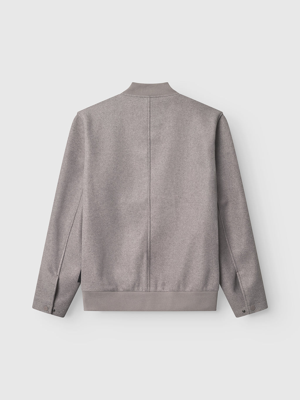 The Orta Wox - Sand bomber jacket by Gabba is shown from the back in light gray, featuring a straight center seam, short collar, and buttoned cuffs, set against a plain white background.