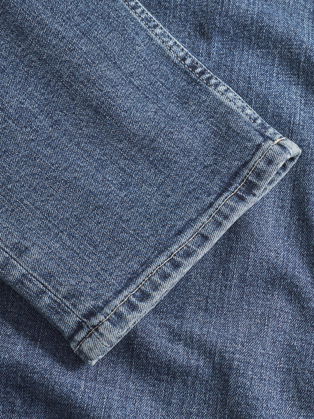 Close-up of the hem of Gabbas Marc Jingo - Dark Blue Denim straight-leg jeans resting on denim, highlighting texture, comfort stretch, and stitching details.