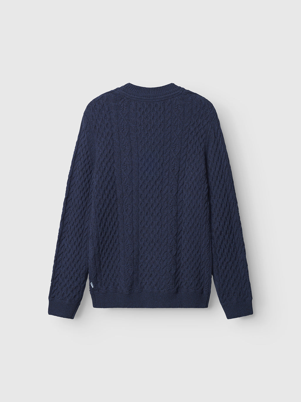 The Gabba Tokyo Cable LS - Navy, a classic men's cable knit sweater, is shown from the back against a plain light gray background.