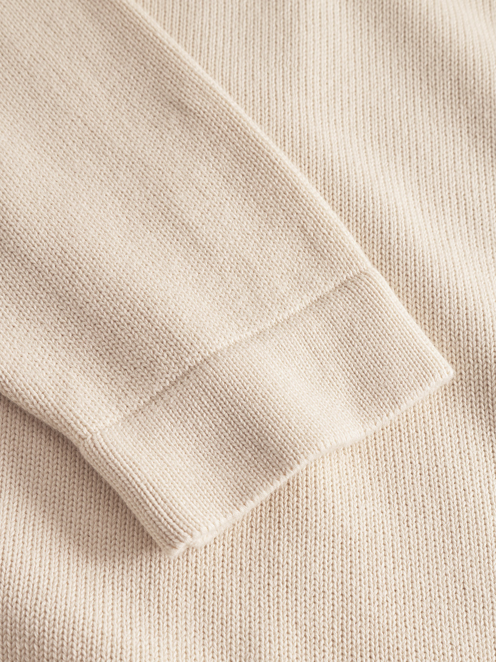 Close-up of the ribbed cuff and textured 100% cotton fabric on the Gabba Sakai Wong LS sweater in White Almond.