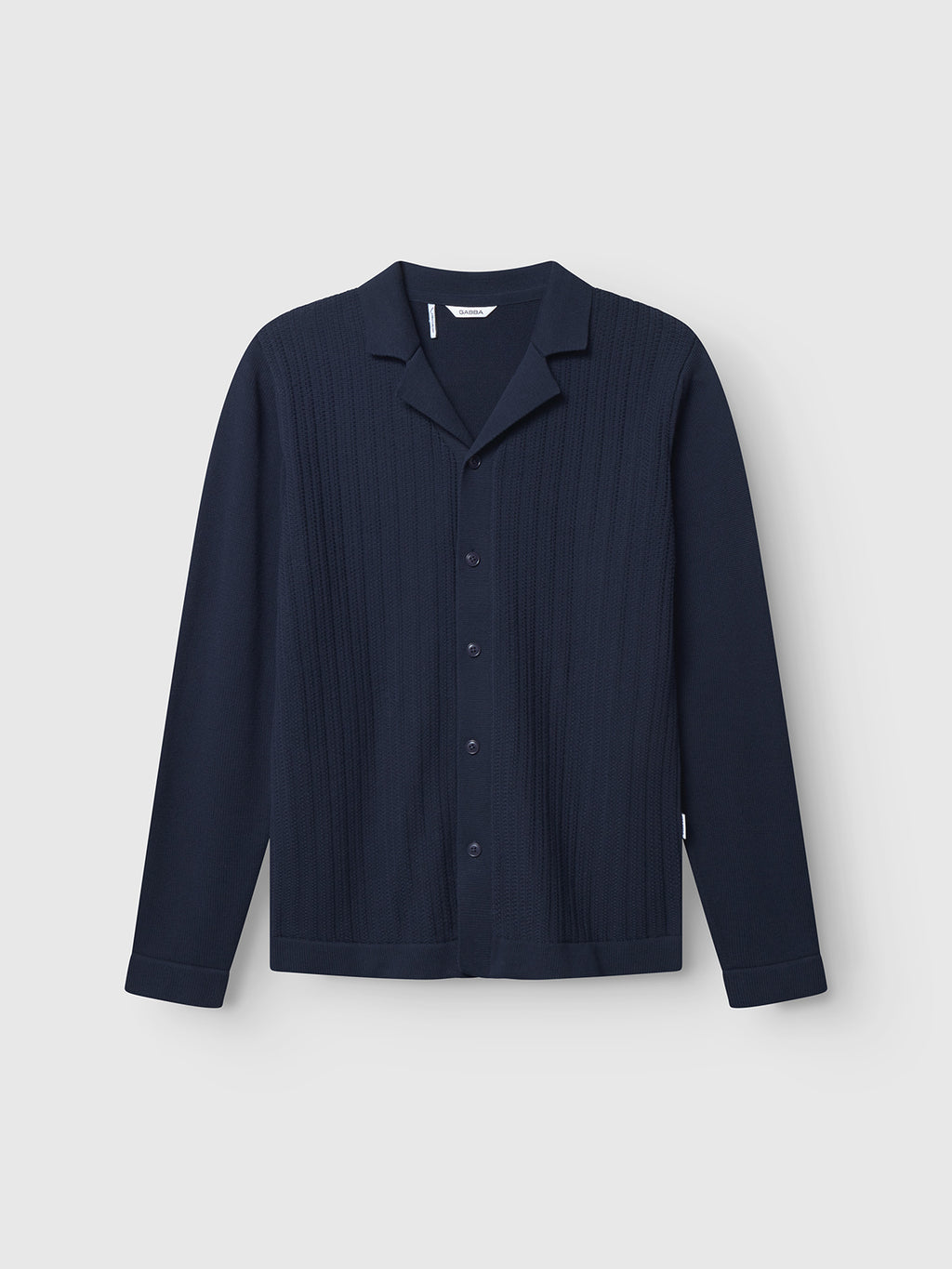 The Gabba Sakai Wong LS - Navy is a long-sleeve, button-up shirt featuring a resort collar and subtle vertical textured pattern on the front, crafted from soft cotton knit, shown against a plain white background.
