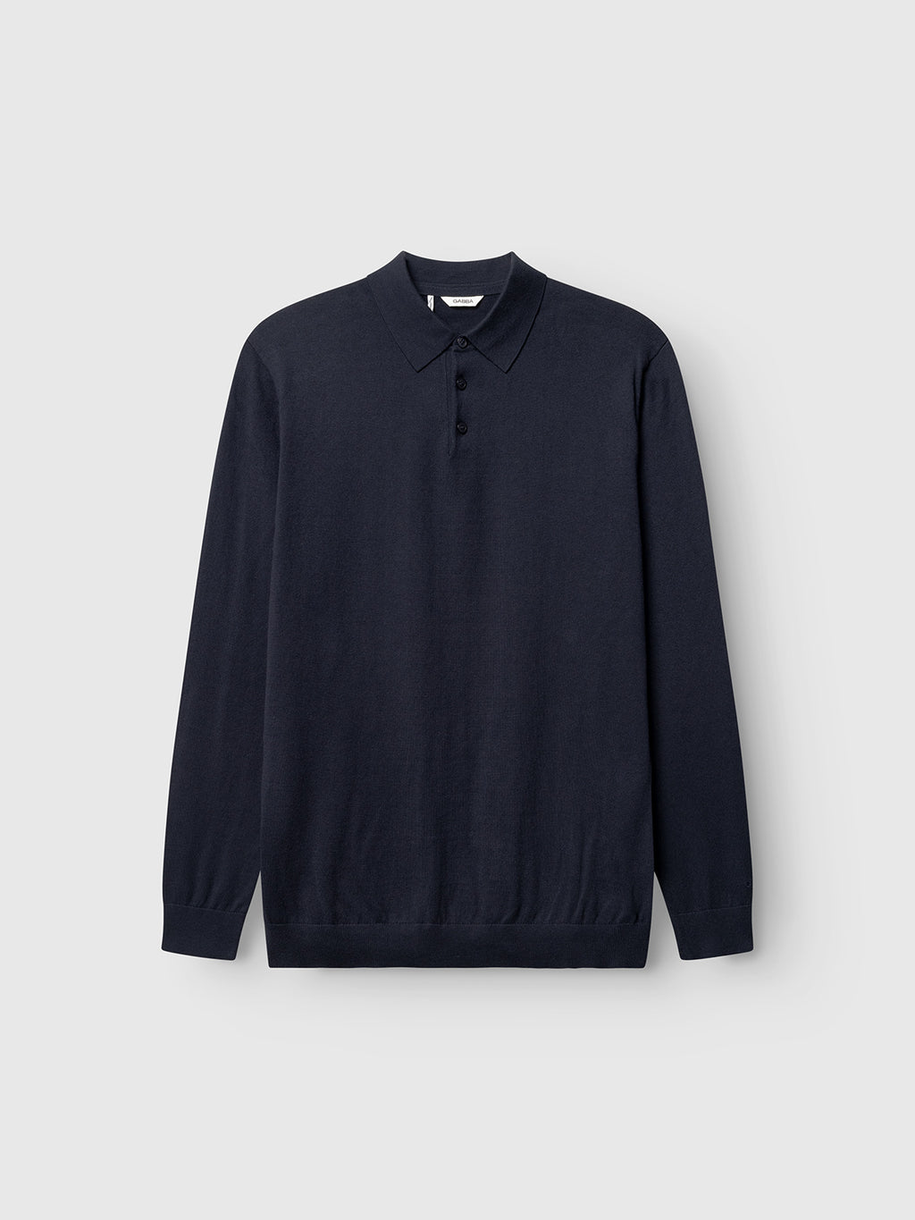 The Gabba Akita Prex LS in navy is a long-sleeved polo knit shirt with a collar and three buttons, shown on a light gray background—a modern essential with subtle Gabba branding.