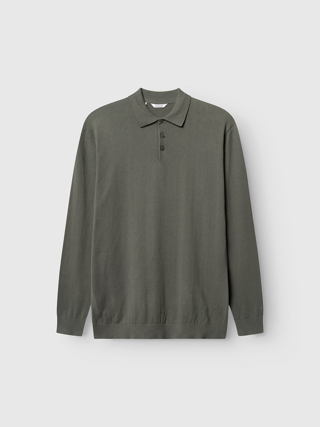 The Gabba Akita Prex LS in Dust Sage Green is a long-sleeve, collared polo with three buttons, made from a soft cotton-cashmere blend and shown on a plain light gray background.