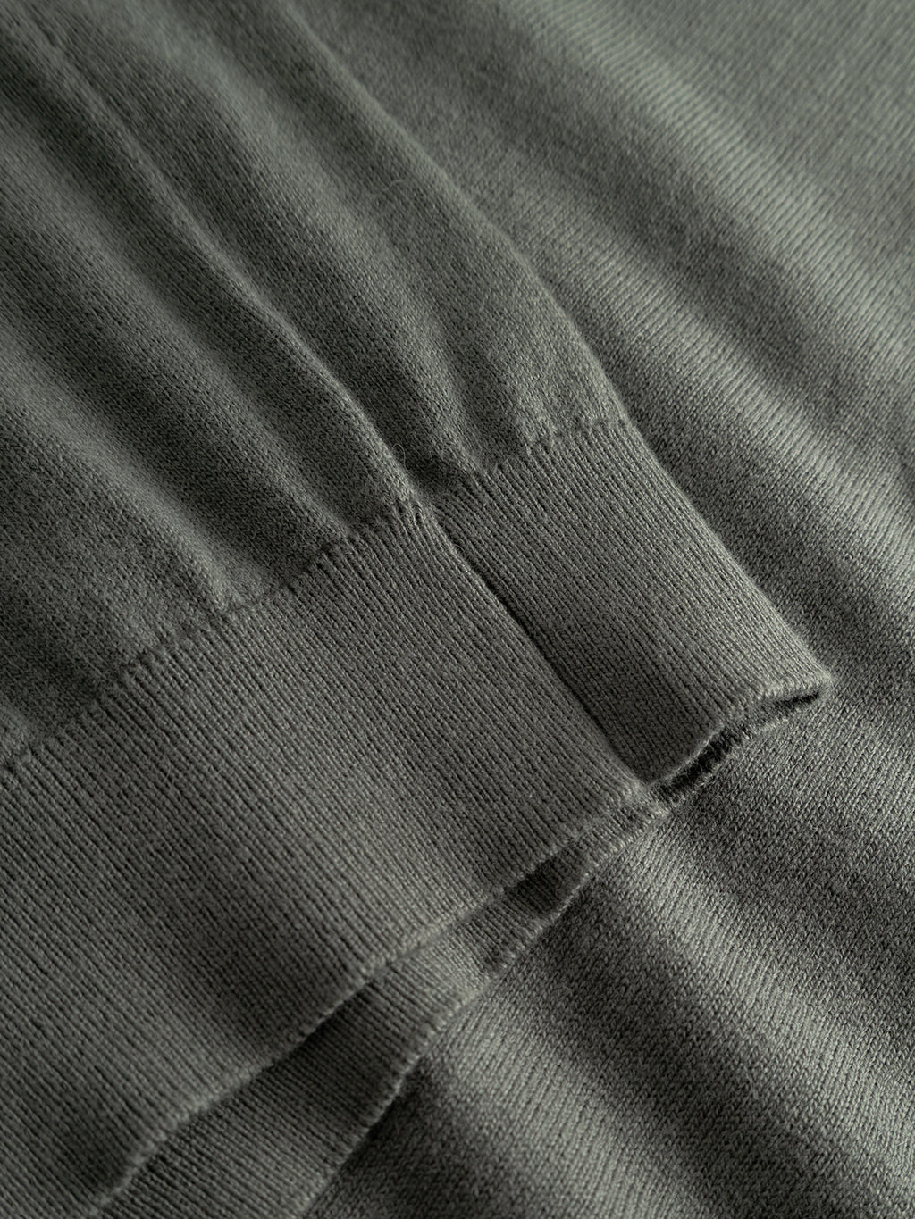 Close-up of the Akita Prex LS - Dust Sage Green by Gabba, highlighting its soft gray knitted cotton-cashmere blend and ribbed cuff detail, with visible stitching and luxurious texture.
