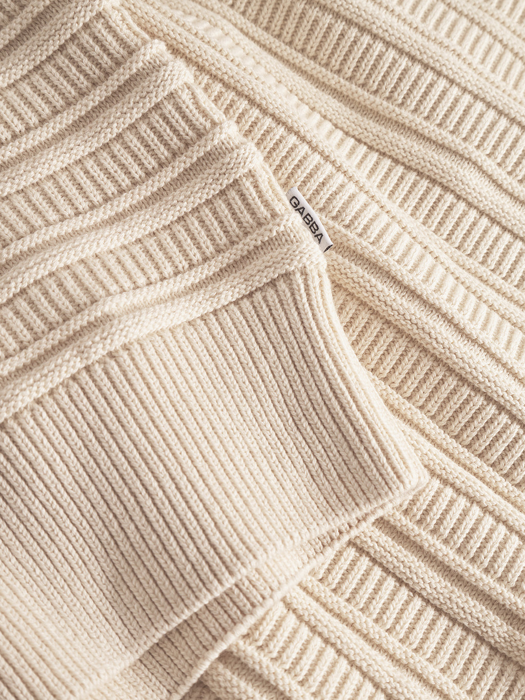 A close up of the Gabba Iwaki Buco LS - White Almond, showcasing its textured knitted fabric.