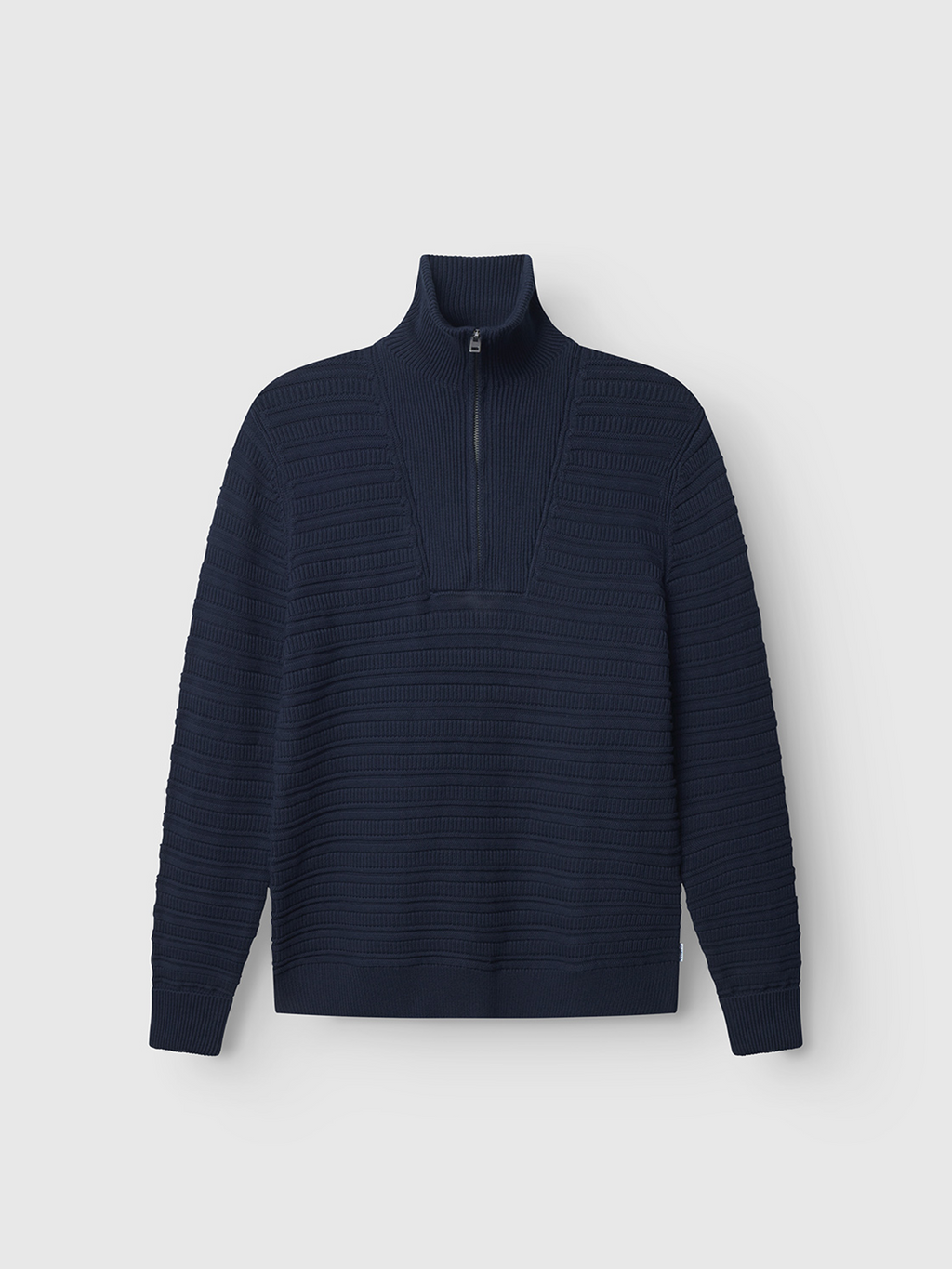 The Gabba Iwaki Buco LS - Navy, a long-sleeve cotton jumper with a ribbed texture, high collar, and partial front zipper, is shown on a plain light gray background.