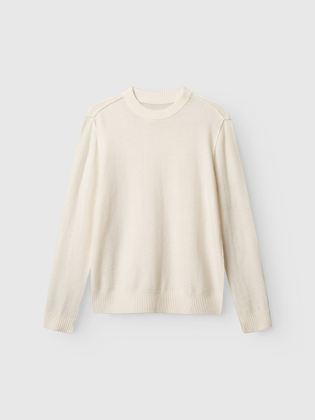 The Gabba Tokota Aico LS in off white is a plain, long-sleeve sweater featuring a crew neck, ribbed cuffs, and hem—an ideal wool layering piece—shown against a light gray background.