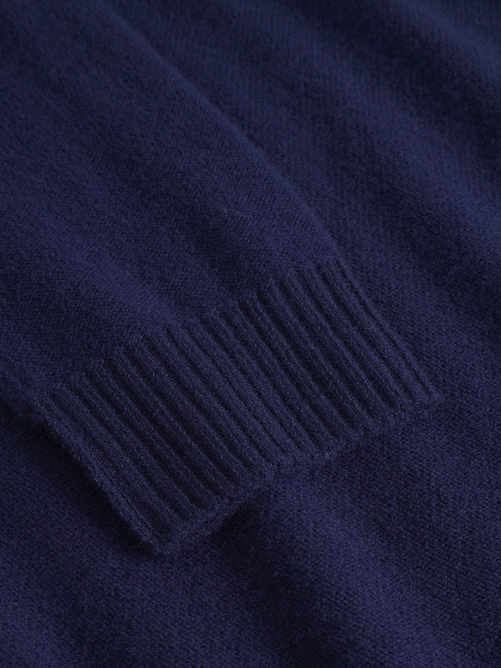 Close-up of the Gabba Tokota Aico LS in Dark Navy, showcasing the ribbed cuff detail on the merino knit sleeve—a versatile layer for any wardrobe.