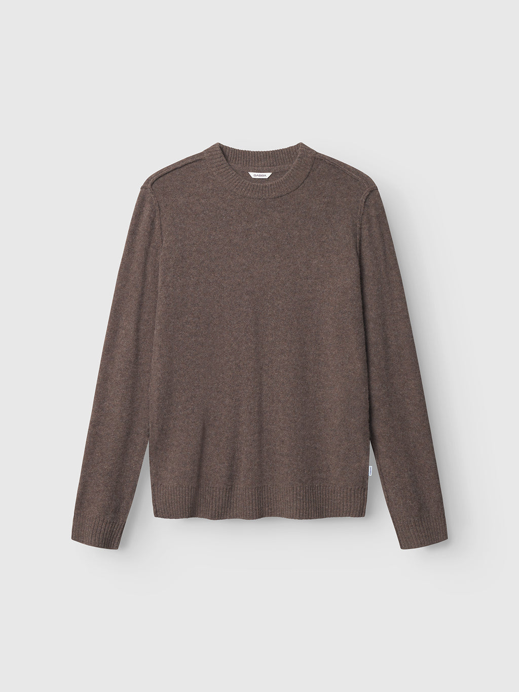 The Gabba Tokota Aico LS in dark brown is a crew neck sweater made from merino wool with ribbed cuffs, collar, and hem, shown against a plain light background.