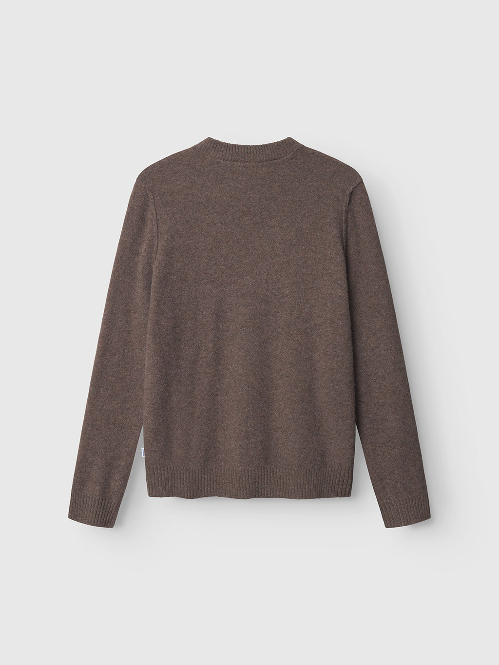 The Gabba Tokota Aico LS sweater in dark brown is shown from the back, laid flat on a light gray background. The crew neck features ribbed collar, cuffs, and hem.