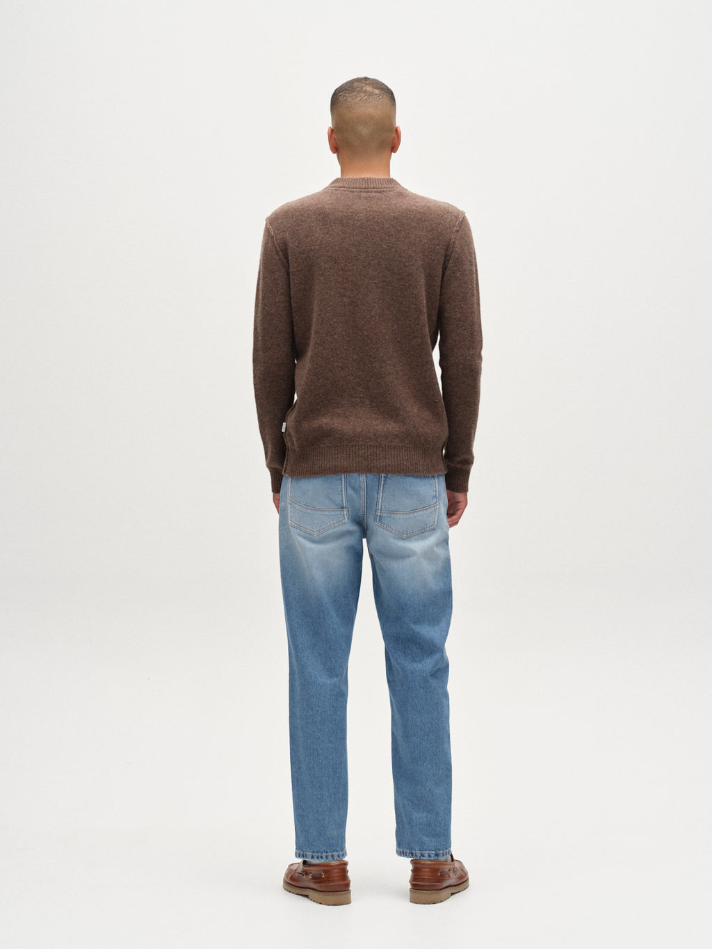 A man in a Gabba Tokota Aico LS crew neck sweater in dark brown.