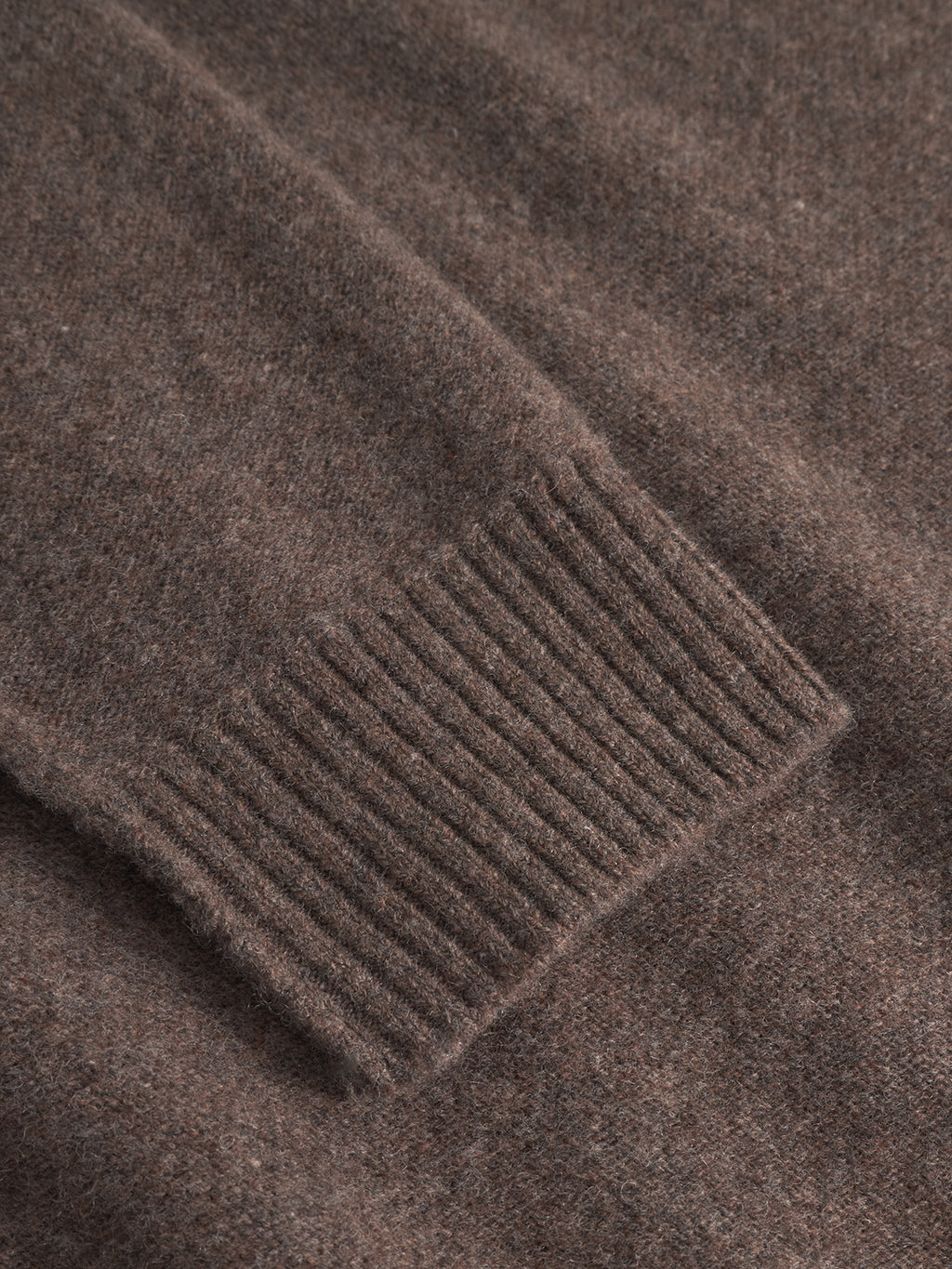 Close-up of a Gabba Tokota Aico LS - Dk. Brown merino wool sweater sleeve, highlighting the ribbed cuff and fabric texture.