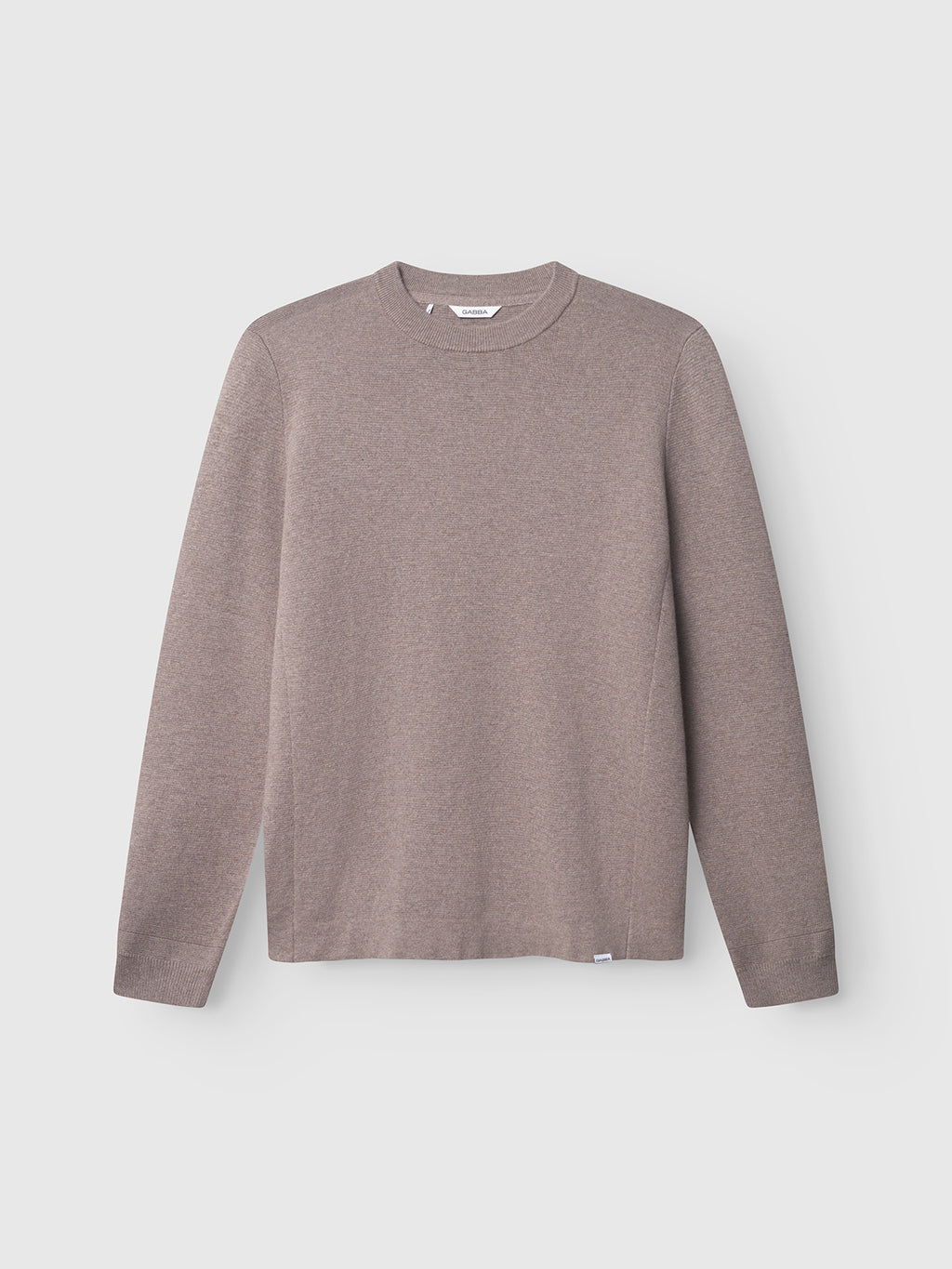 The Gabba Blanko New LS in Sand Mel. is a long-sleeved, crew-neck sweater made from breathable Milano knit, ideal for comfortable transitional layering. Displayed on a light gray background.