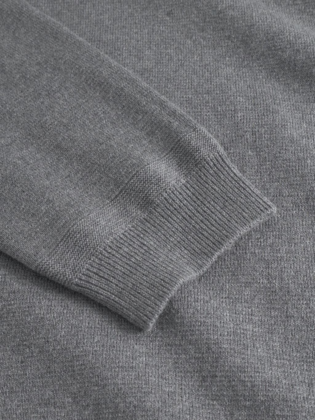 Close-up of the Gabba Blanko New LS in Dk. Grey Mel, showcasing the ribbed cuff and soft Milano knit texture that sets this premium sweater apart.
