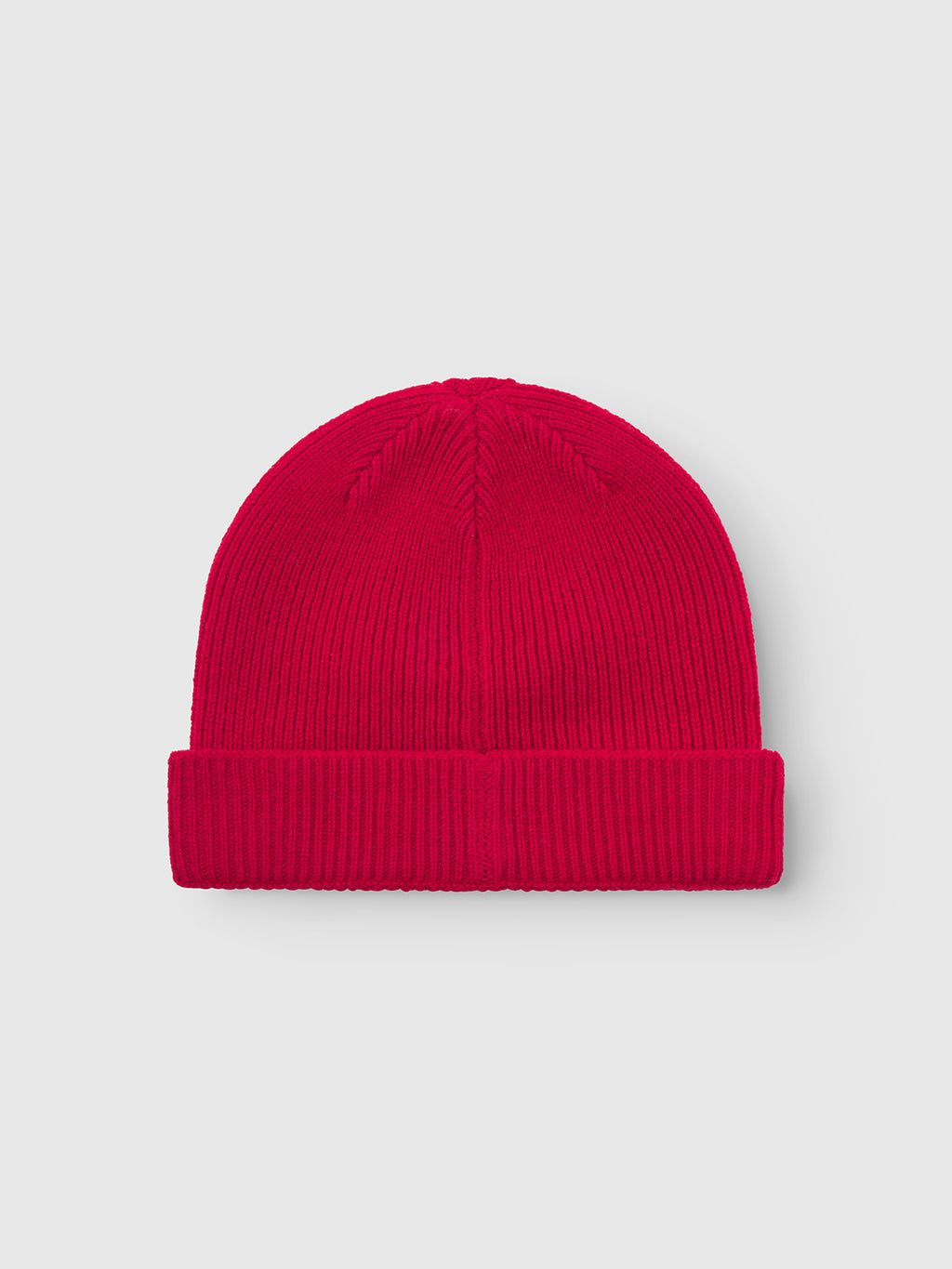 The Gabba Biella Aico - Red is a bright red, ribbed knit beanie with a folded brim, made from soft merino wool and shown on a plain light gray background.