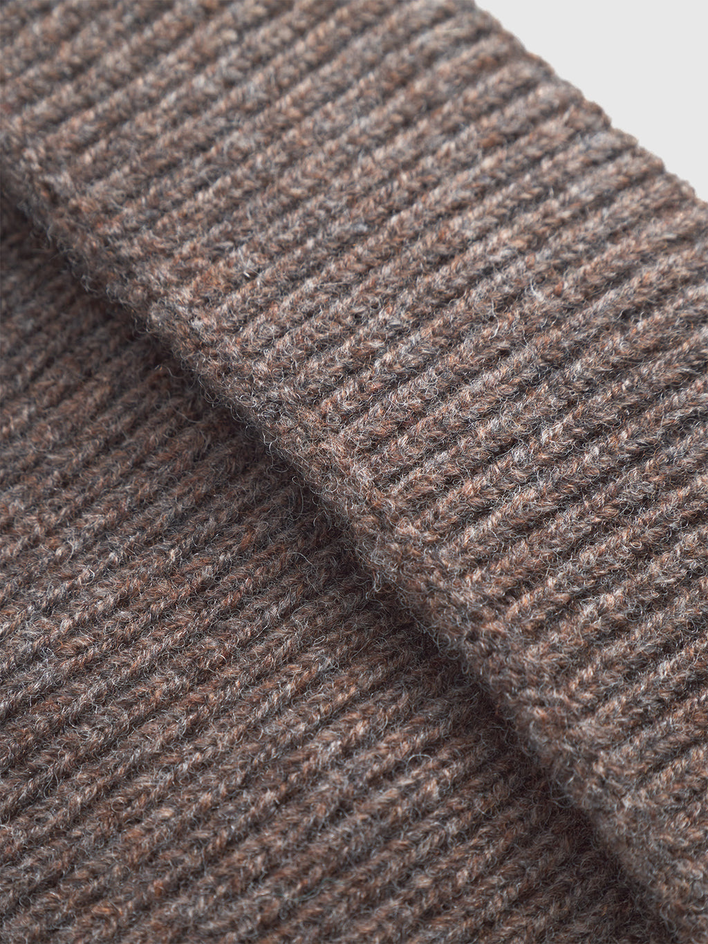 Close-up of Gabba’s Biella Aico - Dk. Brown, a 100% wool knit fabric. Detailed ribbed texture and weave pattern showcase its soft, cozy look—ideal for stylish cold-weather outfits.