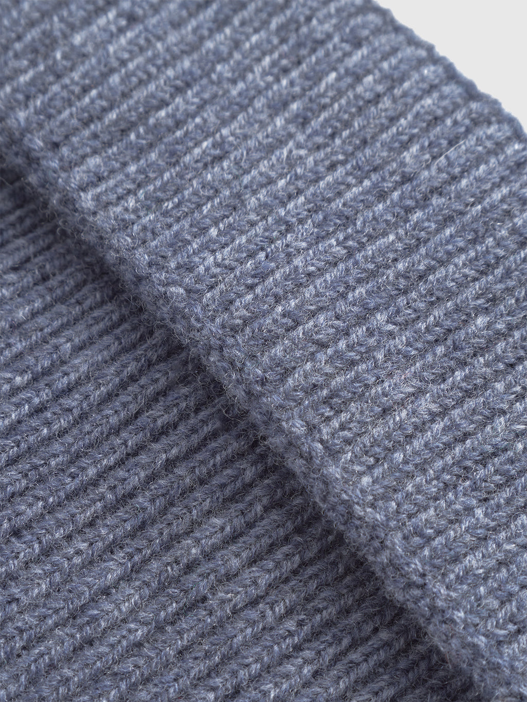 Close-up of the Gabba Biella Aico beanie in vintage indigo, featuring a gray ribbed knit and folded edge—ideal for lovers of classic merino style.