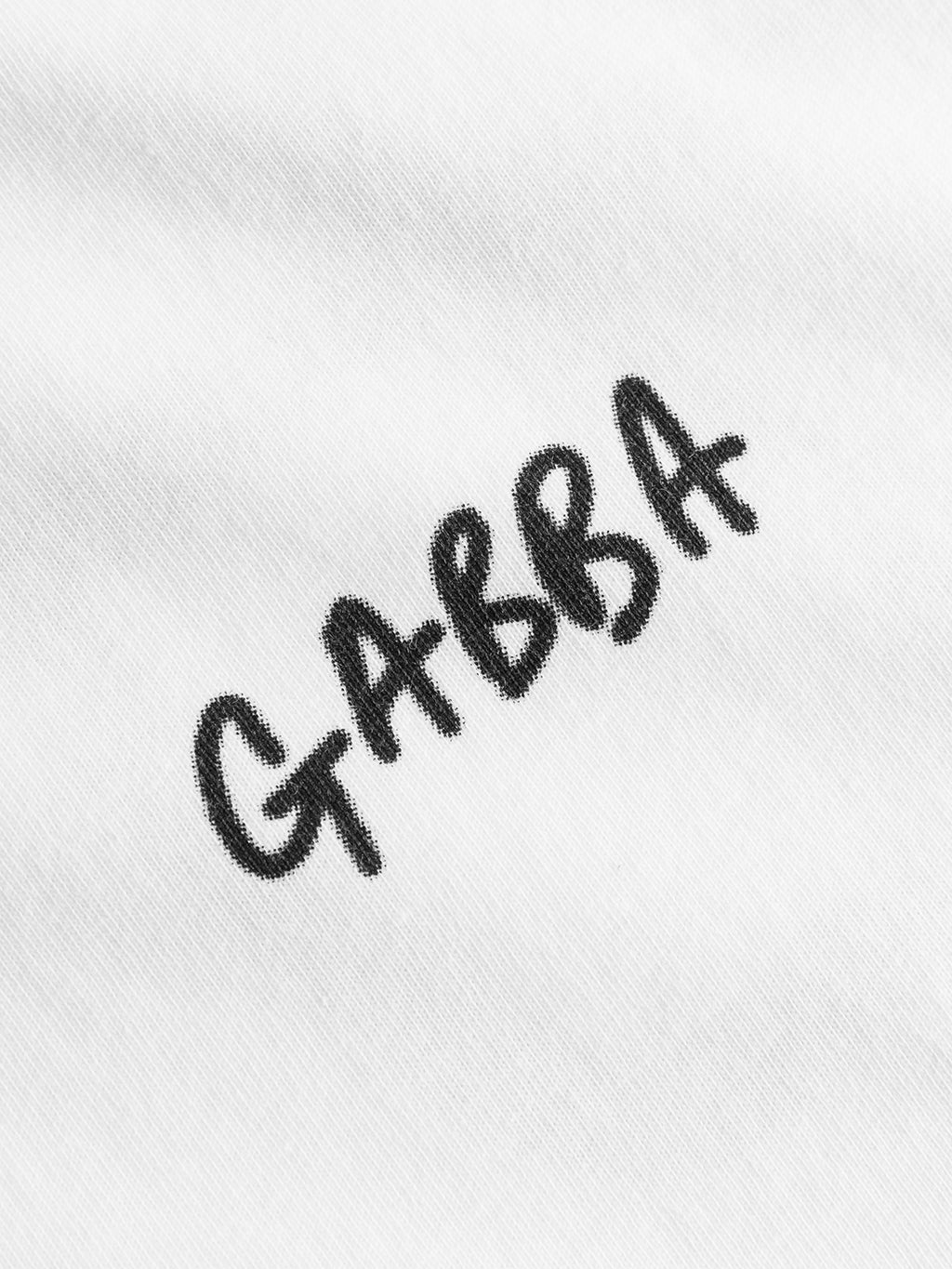 Close-up of the Gabba Dune Kay Dot SS GOTS T-shirt in white, featuring bold black handwritten-style GABBA lettering—a standout from the Gabba x Kay collection.