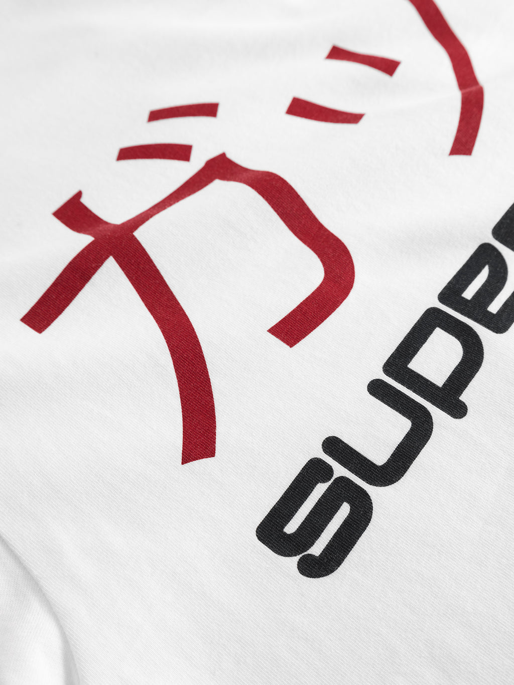 Close-up of Gabbas Dune Kay Dot SS GOTS T-shirt in white, made from organic cotton, with bold red Japanese characters and the black word SUPER—part of the SUPERNORMAL-themed Gabba x Kay collaboration.