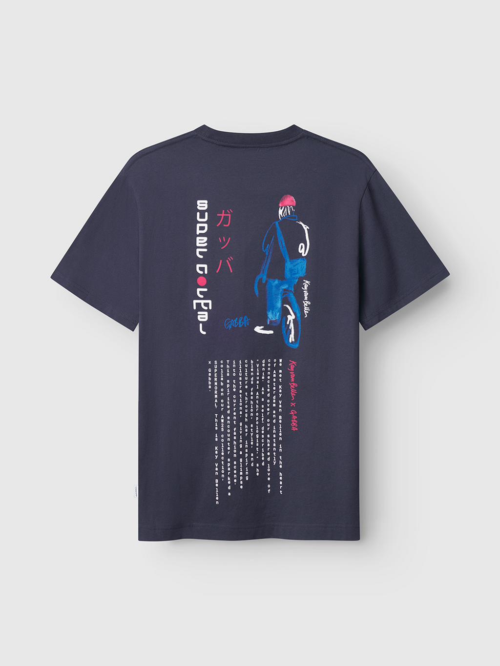 The Dune Kay Man SS GOTS tee by Gabba is a navy blue organic cotton shirt with a back graphic of a stylized blue and pink figure, vertical Japanese-inspired minimal text, SUPERNATURAL in white, and extra white text at the bottom.