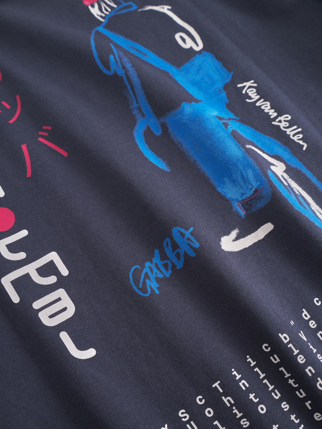 Close-up of the Gabba Dune Kay Man SS GOTS - Navy tee: a navy blue organic cotton shirt with an abstract figure, blue bag, stylized text, and signatures—Kay van Bellen & Gabba—in white and blue, inspired by Japanese minimalism.