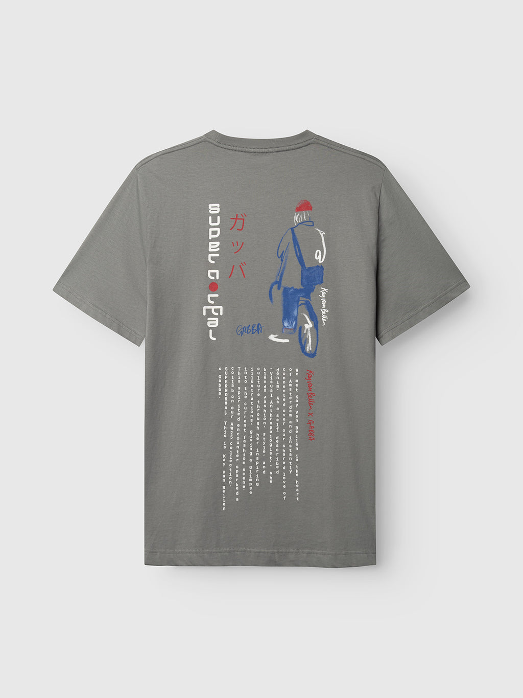 Gabba’s Dune Kay Man SS GOTS tee in Dust Sage Green features an artist print of a helmeted figure with a bicycle, “SUPER RACER” in Japanese and English, extra Japanese text, and is crafted from GOTS-certified cotton.