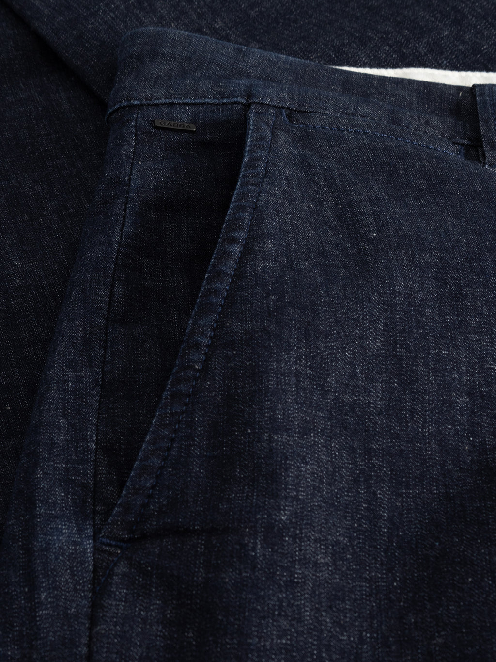 Close-up of Paul Sisu - Dark Denim slim fit jeans by Gabba, featuring a textured, slightly faded dark blue stretch denim with visible side pocket, waistband, and zipper area.