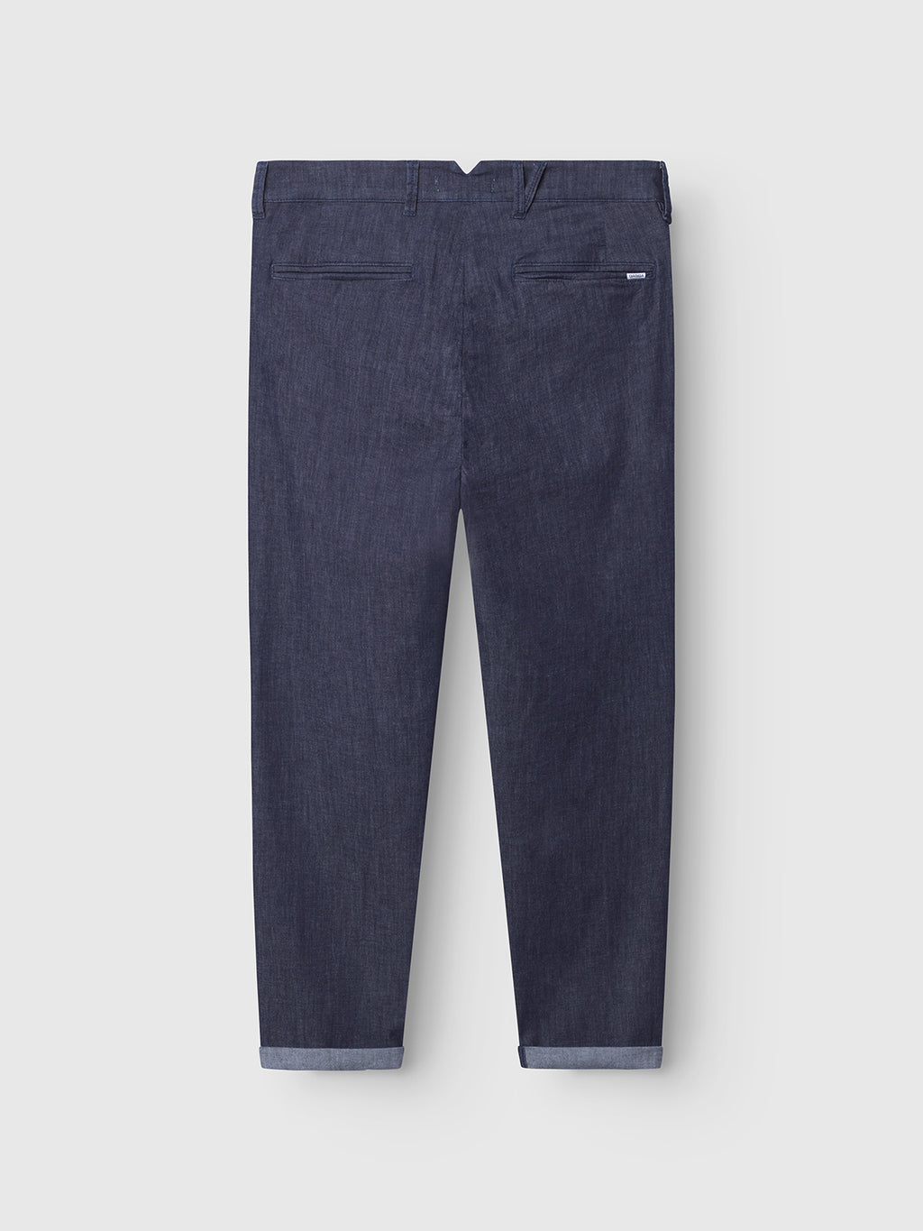 The Gabba Firenze Sisu - Dark Denim jeans are shown from the back with two welt pockets and rolled-up cuffs, made from super-stretch fabric in a relaxed tapered fit, displayed on a plain light grey background.