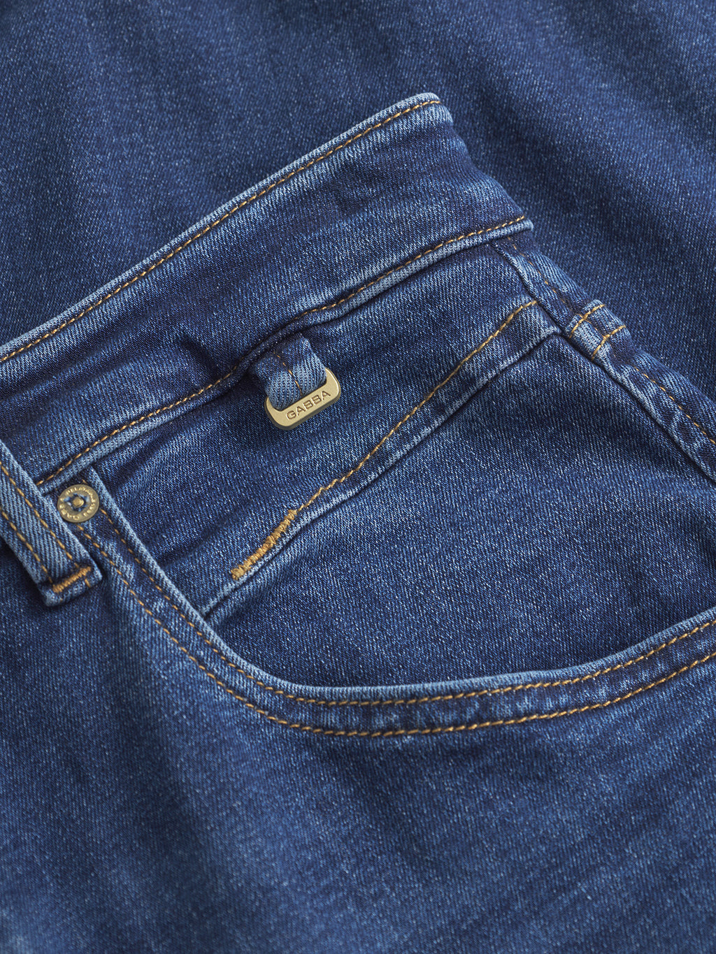 Close-up of Gabbas Alex Just - Dark Blue Denim jeans featuring a relaxed tapered fit, front pocket, brass rivet, visible orange stitching, and stretch weave for comfort.