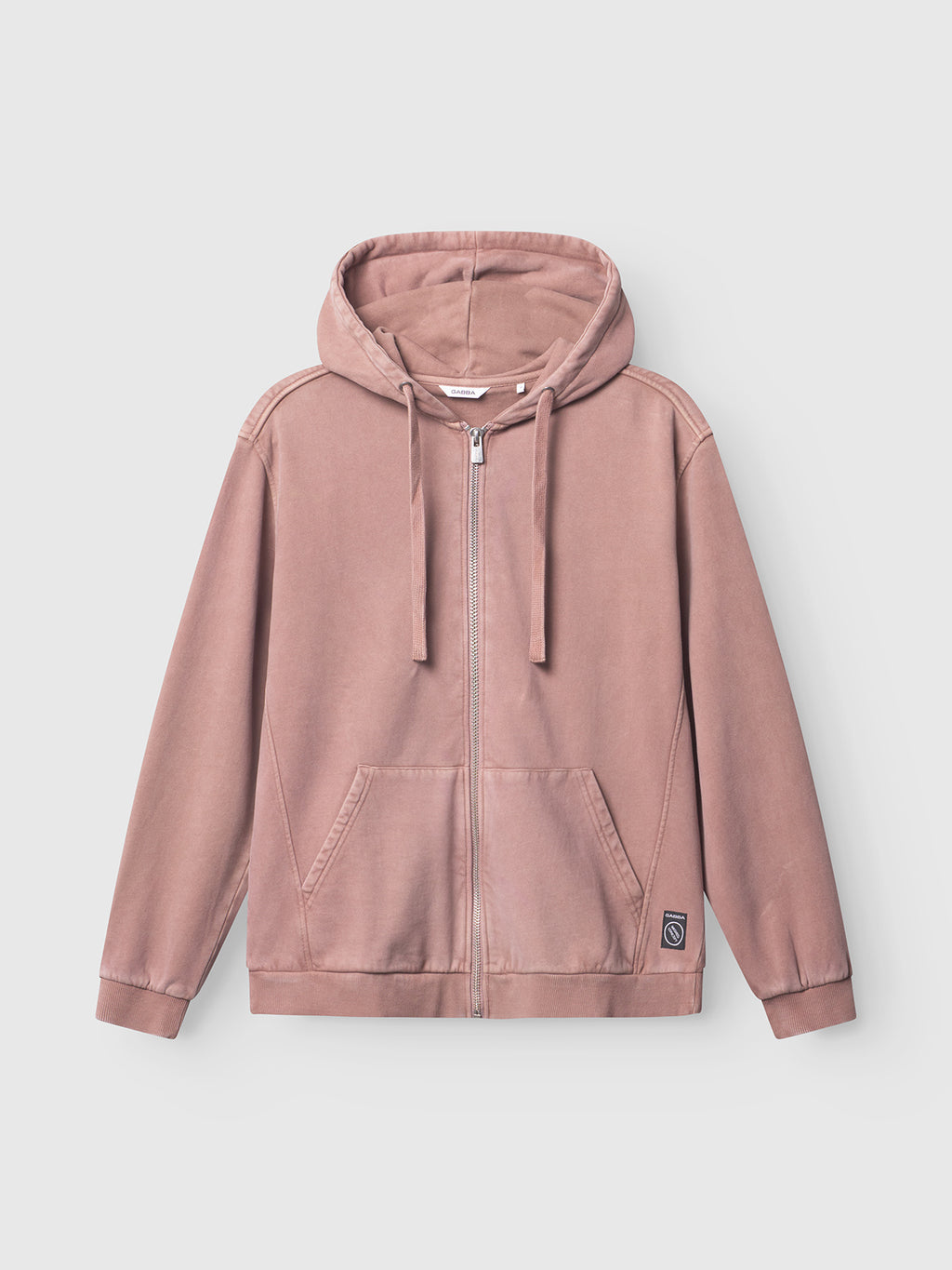 The Delphi Bump GWC - Rose by Gabba is a dusty pink zip-up hoodie featuring a drawstring hood, front pockets, and a small black patch near the hem. Displayed on a plain background, it embodies Gabba’s understated black label style.